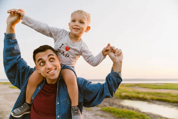 Young White Happy Father Carrying Little Son His Shoulders While — стоковое фото