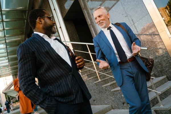 Multiracial Men Dressed Suits Talking Gesturing While Going Stairs Outdoors — Foto Stock