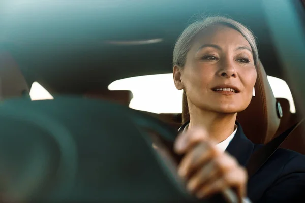 Mature Asian Woman Grey Hair Using Earphone While Driving Car — Foto Stock