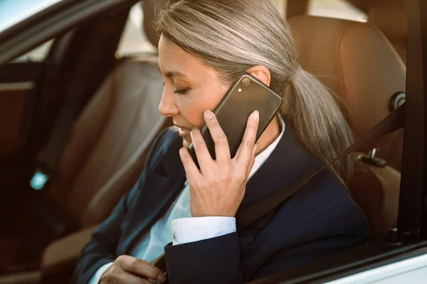 Mature Asian Businesswoman Talking Cellphone While Driving Car — Foto de Stock