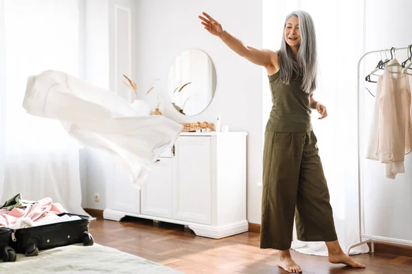 Mature Asian Woman Grey Hair Smiling While Packing Suitcase Home — Fotografia de Stock