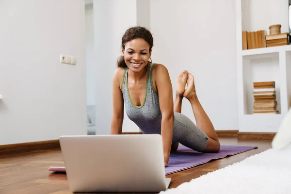 Young Black Woman Using Laptop Yoga Practice Home — стоковое фото