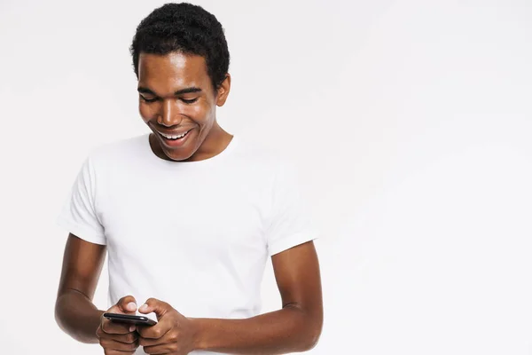 Young Black Man Shirt Smiling Using Cellphone Isolated White Background — Stock Fotó