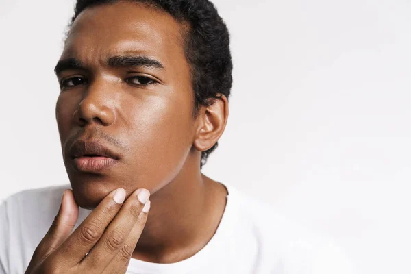 Young Black Man Looking Camera While Touching His Skin Isolated — Stockfoto
