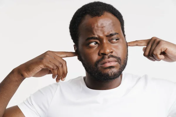 Black Bristle Man Looking Aside While Plugging His Ears Isolated — Photo