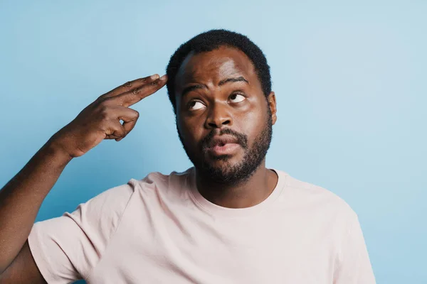 Black Confused Man Shirt Making Shot Gesture Isolated Blue Background — Stockfoto