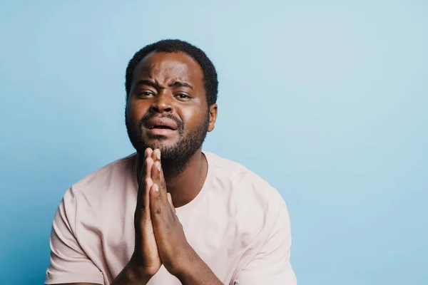 Black Bristle Man Crying While Holding His Palms Together Isolated — Stockfoto