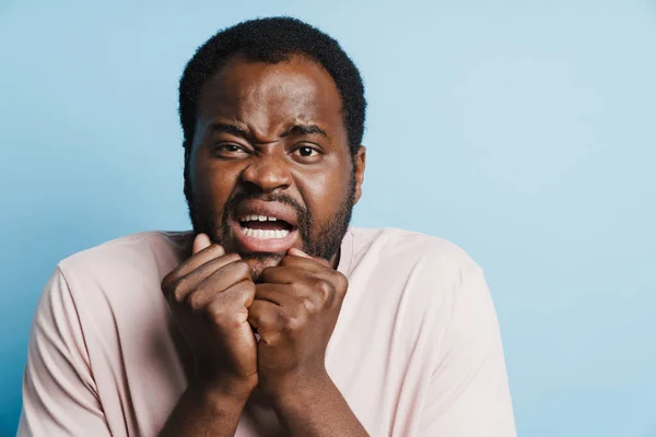 Black Scared Man Grimacing While Posing Clenched Fists Isolated Blue — Stok fotoğraf