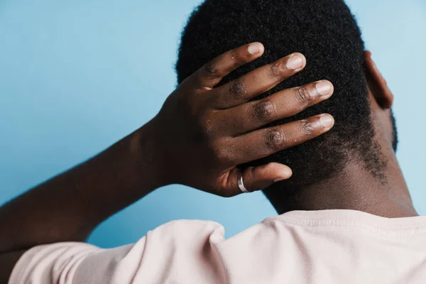Black Bristle Man Shirt Rubbing Back His Head Isolated Blue — Stok fotoğraf