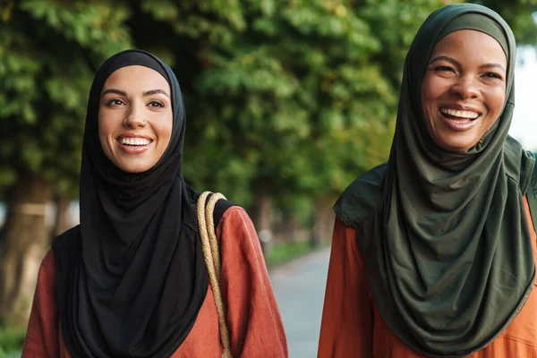 Multiracial Muslim Women Laughing While Walking Together Outdoors — Stockfoto