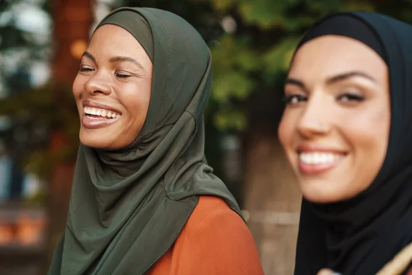 Multiracial Muslim Women Laughing While Walking Together Outdoors — Stockfoto