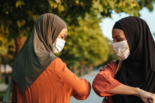 Multiracial Muslim Women Face Masks Elbows Bumping While Walking Together — Stok Foto