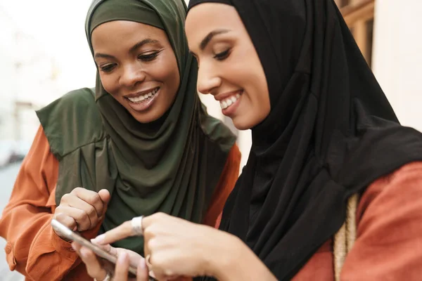 Multiracial Muslim Women Using Mobile Phone Walking City Street — Stockfoto