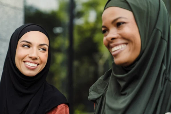 Multiracial Muslim Women Laughing While Walking Together Outdoors — Stockfoto