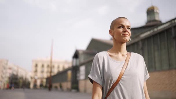 Positive Bald Woman Wearing Shirt Walking Outdoors — Video Stock