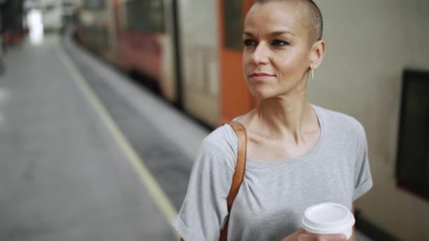 Positive Bald Woman Wearing Shirt Walking Platform Cup Coffee — 비디오