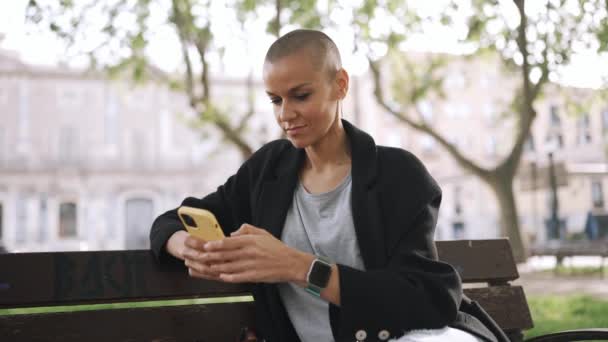 Pensive Bald Woman Texting Phone Bench Park — Stockvideo