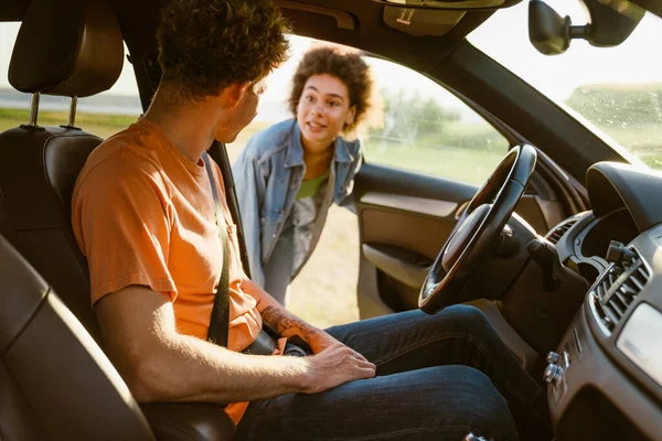 Young Multiracial Couple Talking Looking Each Other Car Trip — Stockfoto