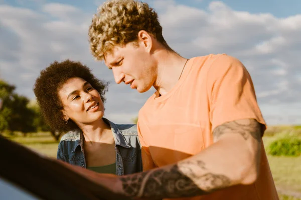 Young Multiracial Couple Talking Examining Map Car Trip — Stock Fotó