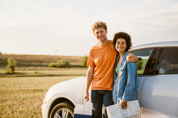 Young Multiracial Couple Smiling Hugging Car Trip — стоковое фото