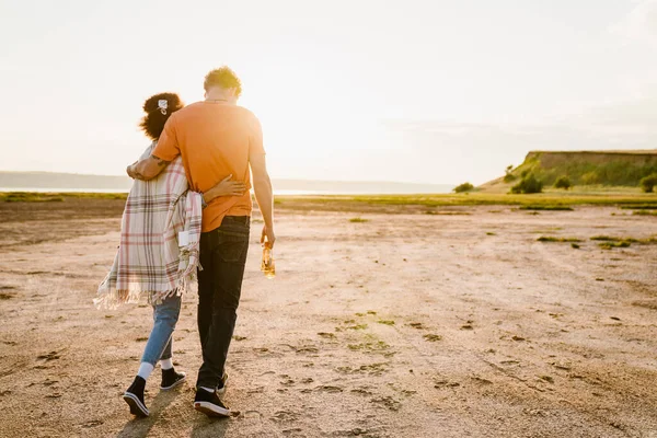 Young Multiracial Couple Hugging While Walking Together Picnic — Stockfoto