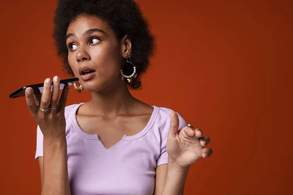 Young Black Woman Gesturing While Using Mobile Phone Isolated Brown — Stok fotoğraf