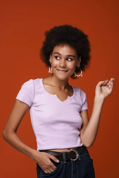 Black Young Woman Earrings Gesturing Smiling Camera Isolated Brown Background — Zdjęcie stockowe