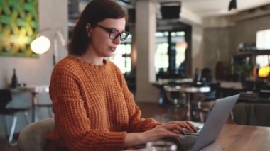 Concentrated red haired woman working in cafe