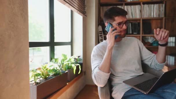 Smiling Man Talking Phone Typing Laptop Office — Stock Video