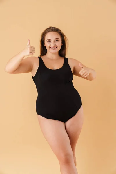 Young Woman Wearing Swimsuit Smiling While Showing Thumbs Isolated Beige — Fotografia de Stock