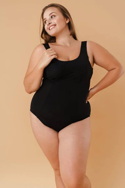 Young Woman Wearing Swimsuit Smiling Looking Aside Isolated Beige Background — 스톡 사진