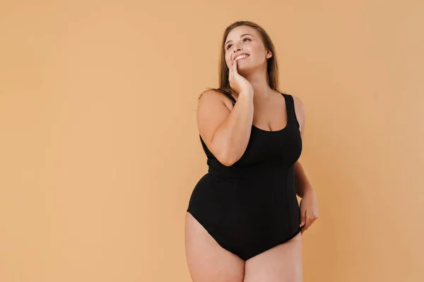 Young Woman Wearing Swimsuit Smiling Looking Upward Isolated Beige Wall — 스톡 사진