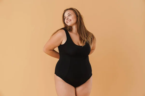 Young Woman Wearing Swimsuit Smiling Looking Aside Isolated Beige Background — 스톡 사진