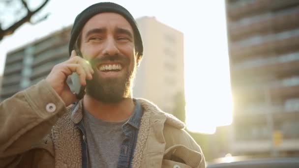 Смеющийся Бородатый Мужчина Шляпе Разговаривает Телефону Улице — стоковое видео