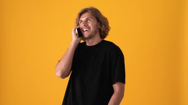 Laughing Blond Man Talking Phone Yellow Studio — Stock Video