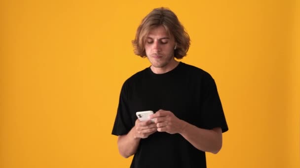 Agradável Loiro Homem Mensagens Texto Por Telefone Ouvir Música Estúdio — Vídeo de Stock