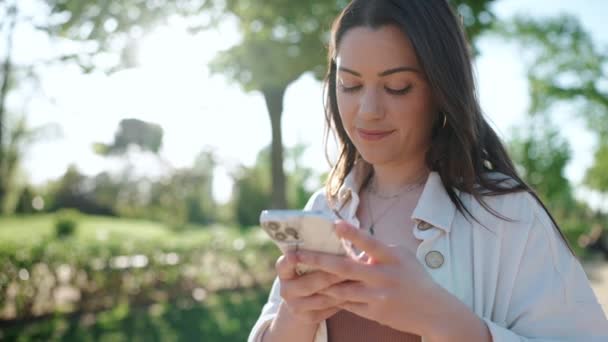 Smiling Brunette Woman Looking Mobile Outdoors — Stock Video