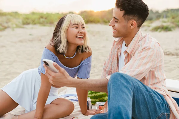 Multiraciaal Koppel Glimlachen Het Gebruik Van Mobiele Telefoon Tijdens Picknick — Stockfoto