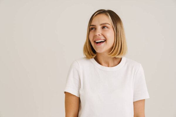 Young Blonde Woman Wearing Shirt Smiling While Looking Aside Isolated Stock Picture