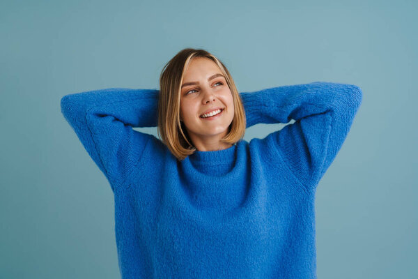 Young Blonde Woman Smiling While Posing Hands Head Isolated Blue Stock Photo