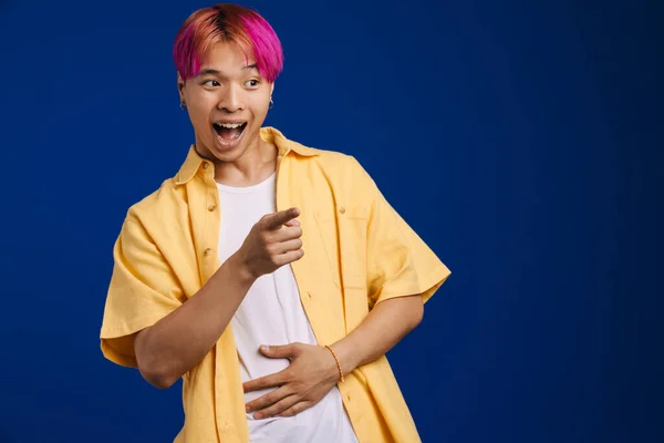 Asijské Chlapec Růžovými Vlasy Smích Zatímco Ukazující Prst Stranou Izolované — Stock fotografie