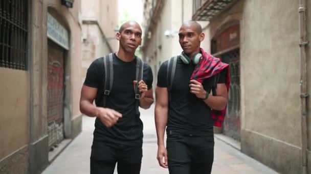 Two Confident Bald African Brothers Walking Pointing Side Street Outdoors — Stock Video
