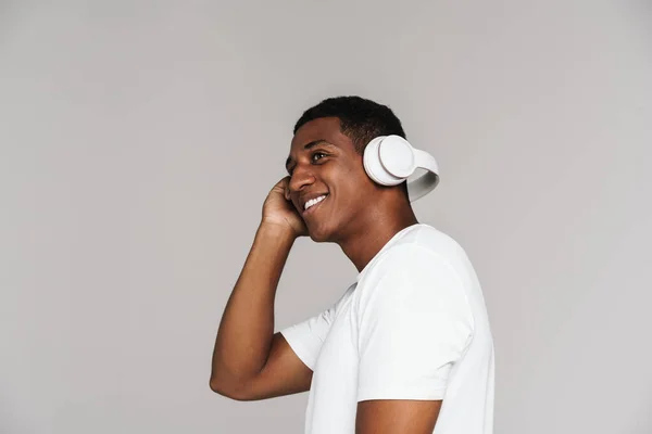 Young Black Man Smiling While Listening Music Headphones Isolated Grey — Stockfoto