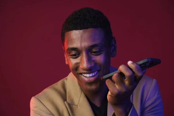 Jonge Zwarte Man Gekleed Jas Praten Mobiele Telefoon Geïsoleerd Rode — Stockfoto