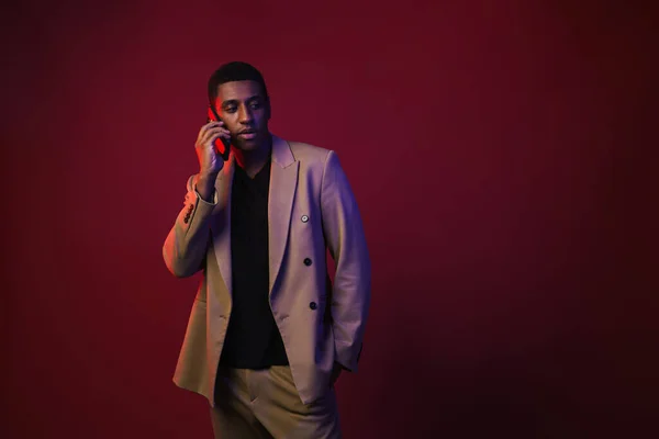 Young Black Man Dressed Jacket Talking Mobile Phone Isolated Red — Stockfoto
