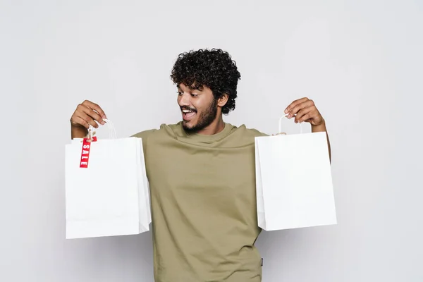 Young Middle Eastern Man Laughing While Posing Shopping Bags Isolated — Stock Fotó
