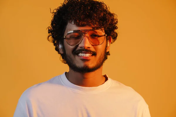 Young Middle Eastern Man Winking While Listening Music Earphones Isolated — Stock fotografie