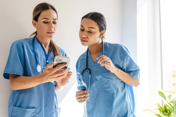 Multiracial Women Doctors Talking Using Cellphone While Working Office Indoors — Foto de Stock