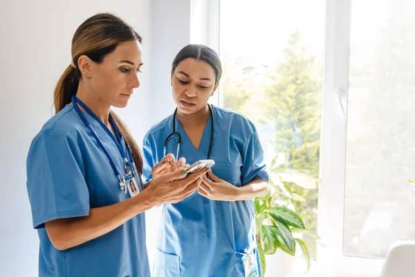 Multiracial Women Doctors Talking Using Cellphone While Working Office Indoors — Foto de Stock