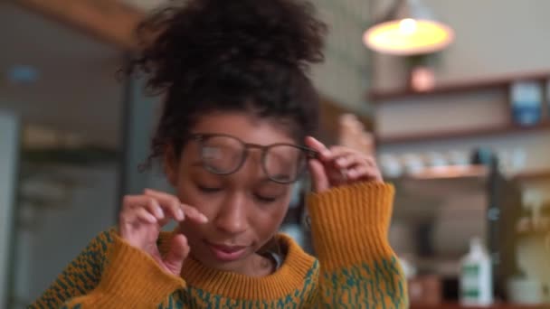 Serious Woman Wearing Yellow Sweater Wipes Her Glasses Cafe — Stock Video